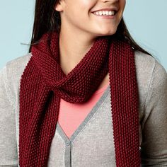 a woman wearing a red scarf and smiling