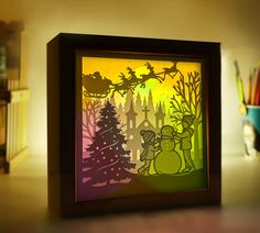 a shadow box that has a christmas scene on it