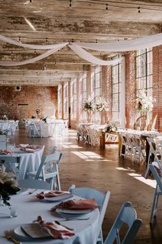 an indoor wedding venue with tables and chairs