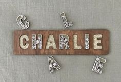 the name charlie spelled with wooden letters and magnets