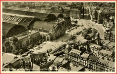 an old black and white photo of a city with lots of buildings in the foreground