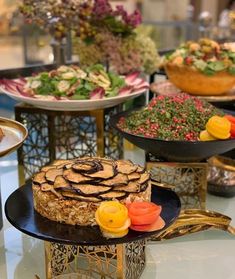 a table topped with lots of different types of cakes and desserts covered in frosting