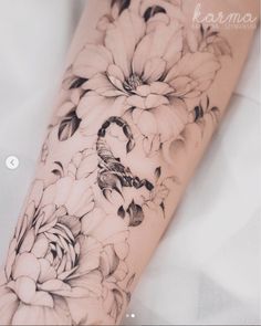 a woman's arm with flowers on it