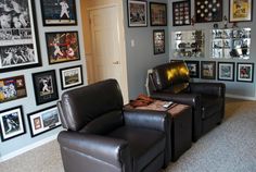 a living room filled with black leather chairs and pictures on the wall