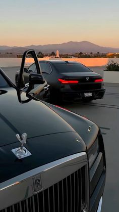 two cars parked next to each other on a parking lot