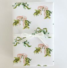 the wrapping paper is decorated with green and pink flowers