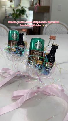 three starbucks beer bottles in a basket on a table with pink ribbon and streamers