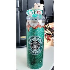 starbucks cup filled with green glitter and teddy bears