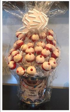 a plastic container filled with red and white cupcakes