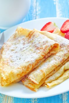 some pancakes and strawberries on a plate