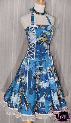 a mannequin wearing a blue dress with an image of batmans on it