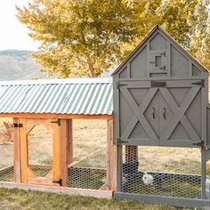 a chicken coop in the middle of a field