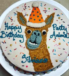 a birthday cake with an image of a llama wearing a party hat