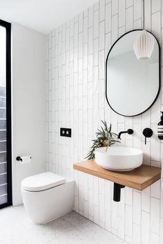 a bathroom with a sink, toilet and mirror