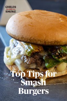 a cheeseburger on a bun with the title top tips for smash burgers