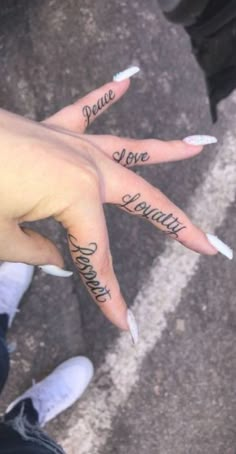 two fingers with words written on them