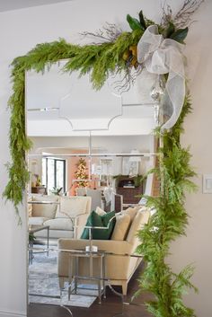 a living room filled with furniture and a mirror