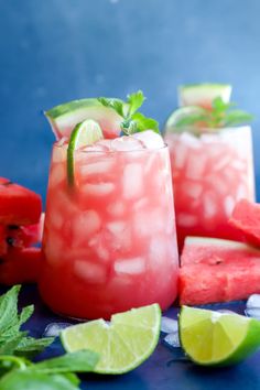 watermelon mojitas with lime and mint garnish on blue background