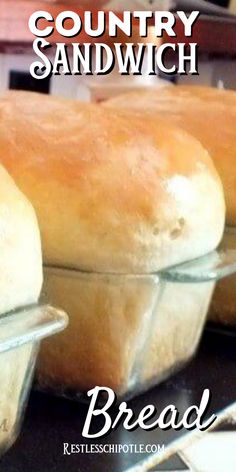 three loafs of bread sitting on top of a counter with the words country sandwich bread