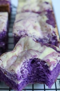 purple cake with white icing sitting on a cooling rack