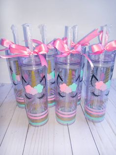 four unicorn tumblers with pink bows on them