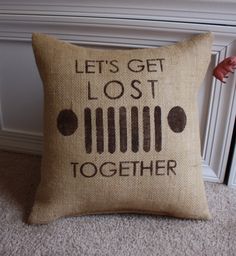 a pillow that says, let's get lost together on the floor next to a radiator