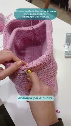 a woman is making a crochet boot out of a knitted shoe cover