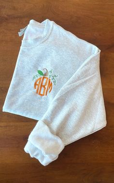 Pumpkin Monogram Embroidered Sweatshirt  Sizes are Unisex  Available in various sizes with the option to change thread colors Also available in shirts, sweatshirts, & hoodies If you don't see the color scheme you want listed, don't hesitate to message us & we'll make it the way you like! Thank you for shopping small!! Sweatshirt Monogram Ideas, Heat Press Sweatshirt Ideas, Fall Sweatshirts Cricut, Casual Halloween Top With Embroidered Logo, Custom Embroidered White T-shirt For Fall, White T-shirt With Custom Embroidery For Fall, White Custom Embroidered T-shirt For Fall, Embroidered White T-shirt For Fall, Fall T-shirt With Embroidered Logo In Relaxed Fit