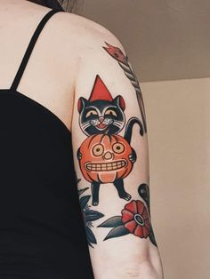 a woman with a cat tattoo on her arm