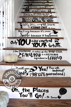 the stairs are decorated with black and white wall decals, as well as pumpkins