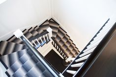 an aerial view of a staircase with black and white carpet