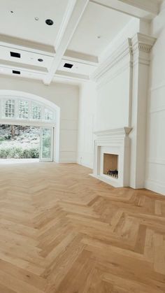 an empty living room with white walls and wood flooring is pictured in this image