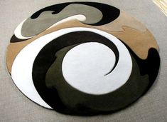 a circular rug with an abstract design on it