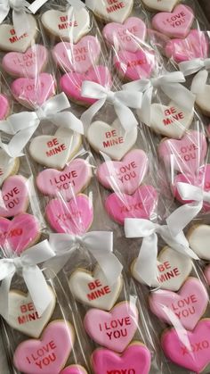 heart shaped cookies with i love you written on them are wrapped in cellophane