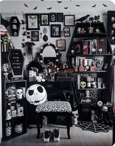 a room filled with lots of black and white decor on the walls, including a halloween themed desk