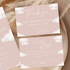 three pink and white wedding thank cards on a plate with feathery furnishing