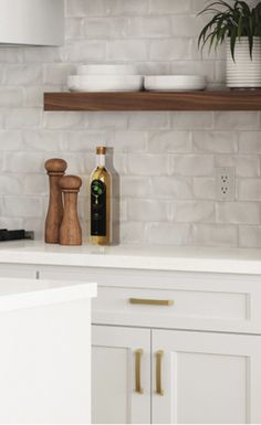 a kitchen with white cabinets and wooden shelves