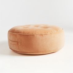 a round ottoman cushion on a white background