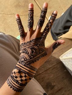 a person's hand with henna tattoos on it