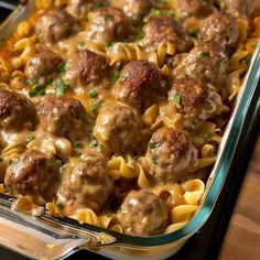 a casserole dish filled with meatballs and noodles