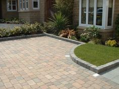 a brick patio in front of a house