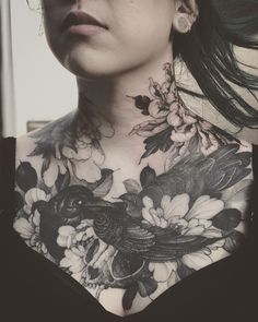 a woman with tattoos on her chest and neck