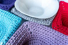 crocheted dishcloths and a white bowl on a table