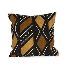 a black and gold pillow on a white background