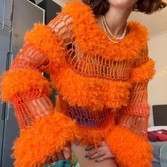 a woman in an orange outfit posing for the camera