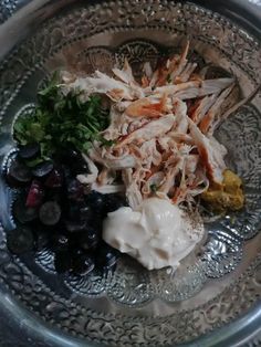 a silver plate topped with different types of food