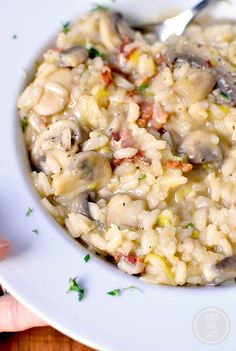 a white bowl filled with pasta and mushrooms