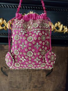 Looking for an ideal traditional Potli bag for your accessories? Here is, perfect Potli bag to carry on your traditional outfits on weddings and festivities.  Design 1: The pink Potli bag features silver embroidery designs on the pure  silk material. (Both side same embroidery).  Design 2: The second design features gota patti and pearl hand crafted potli to complement your ethnic and indian luxury look. Key Features: Embroidery art work This potli is good match with both Indian and western outf Indian Purse, Indian Luxury, Potli Bag, Ethnic Bag, Silver Embroidery, Step By Step Crochet, Creation Crafts, Potli Bags, Wedding Bag