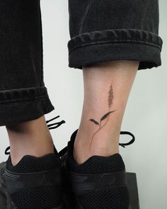 a woman's foot with a small flower tattoo on her left side calfocks