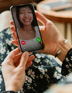 a woman is holding up her cell phone to take a selfie with someone else